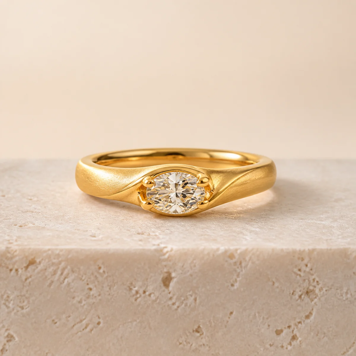 Gold diamond ring on warm stone