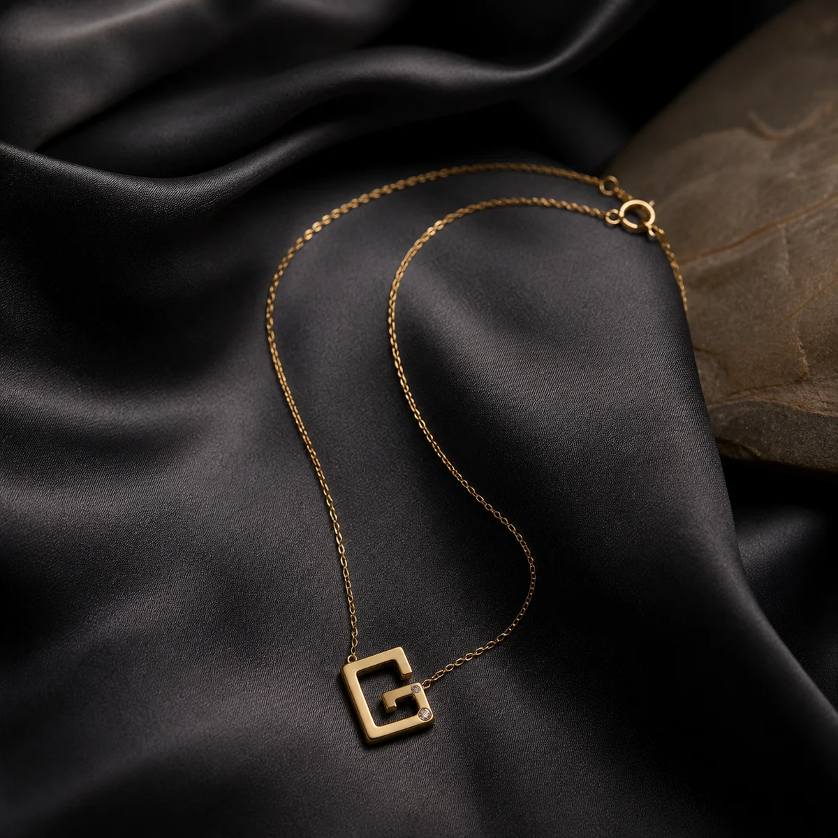 Gharghour geometric gold pendant on charcoal silk